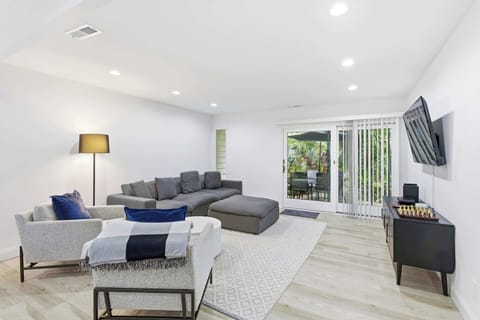 Modern living room with a sectional sofa and sliding glass doors leading to a patio.