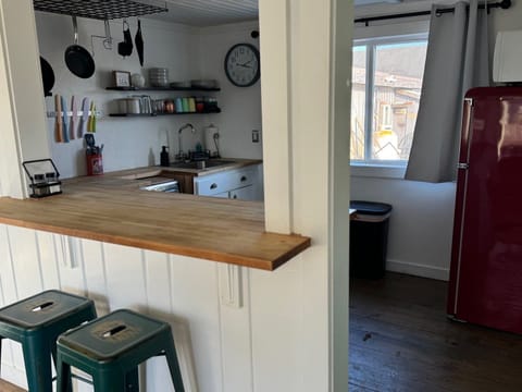 Four bar stools around the kitchen bar is the perfect spot to sit for a quick breakfast.