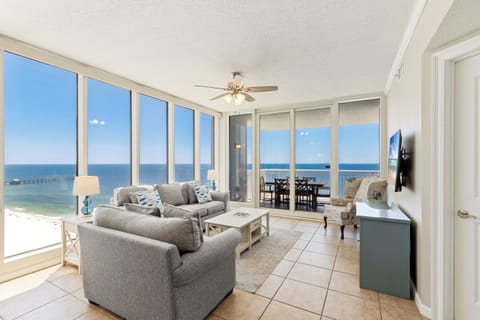 Signature Apartment, 4 Bedrooms, Balcony, Beach View | Living room | 50-inch Smart TV with cable channels, video-game console, books