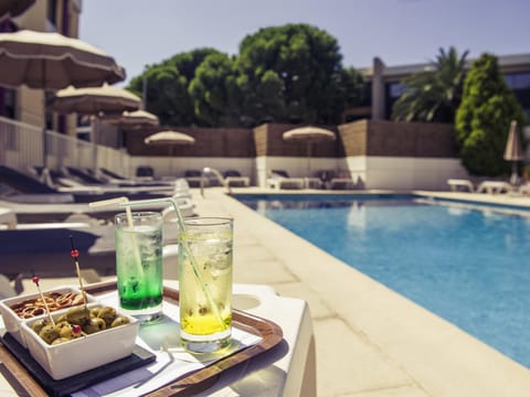 Seasonal outdoor pool, open 9:00 AM to 8:00 PM, pool umbrellas