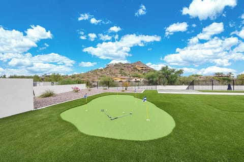 Putting green & turf area next to the pool & spa w/ amazing mountain views