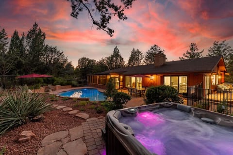 Spacious fully-fenced backyard with 40`x20` pool, 6-person hot tub, and 8-person outdoor dining.