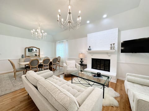 Bright and modern living/dining space with fireplace and TV!