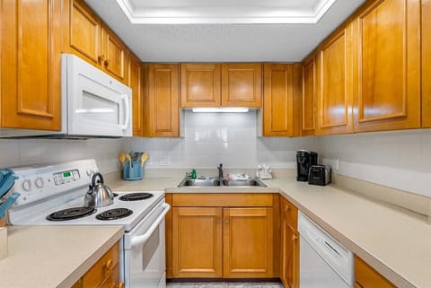 Fully equipped kitchen with stove, oven, dishwasher, microwave, and coffee pot