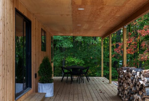 A table for 6 on the large covered porch overlooks the backyard.