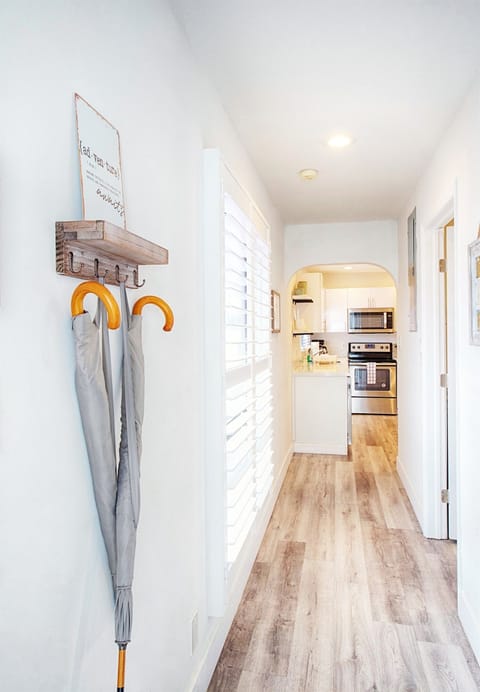 View of hallway with large windows as you enter facing kitchen. Your laundry room and closet door is on your right.