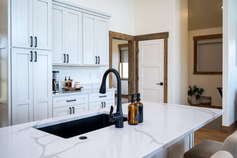 Indulge in culinary delights in the cozy kitchen, equipped with ample amenities for creating wonderful dinners with friends and family.