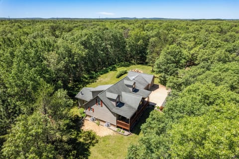 6 acres including trails, firepit, gas and charcoal grills, porch, and deck