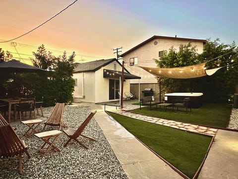 Gated large yard with hot tub, outdoor seating, propane grill, putting golf.