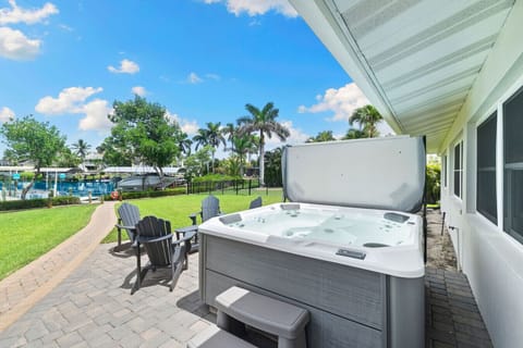 Soak in the private hot tub with breezy bay views and lush green space