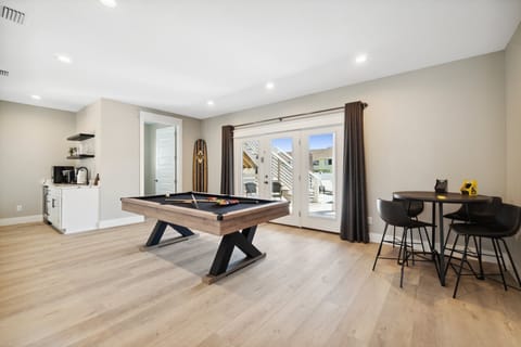 Entertainment-ready game room with pool table and smart TV.