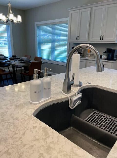 Large island in kitchen with counter height stools.