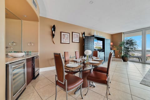 Gather around the elegant dining table, ready for memorable meals and conversations in this beautifully appointed bayfront condo.