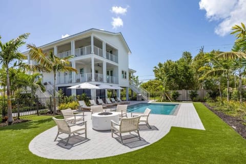 Outdoor entertainment area includes lounge chairs, propane grill, outdoor shower, fire pit, pool table, outdoor TV, and an outdoor dining table!