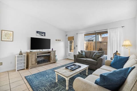 Open-Concept Living Room with Patio Access, Flat Screen TV, Sleeper Sofa and Dining Table