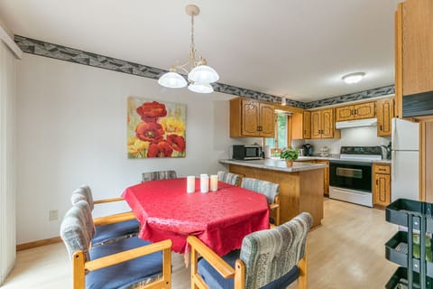 dining area and kitchen next to the walkout to the deck