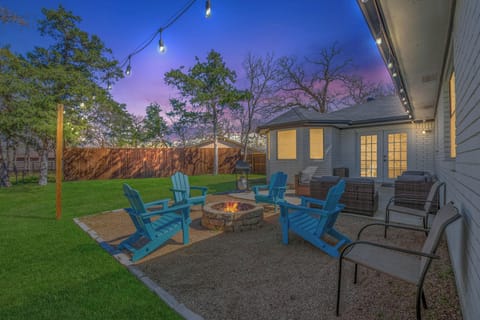 Patio with comfy chairs surrounding a cozy fire pit