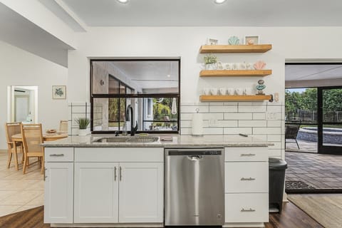 Updated kitchen with pool views from the sink!