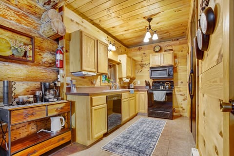 The kitchen's rustic allure exudes a warm and welcoming ambiance, perfect for crafting homemade meals and savoring them with your cherished family and friends.