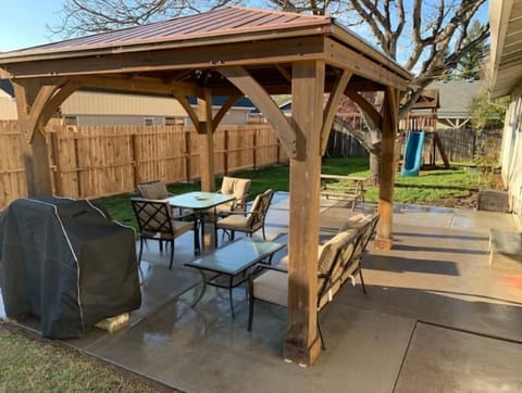 Backyard- covered gazebo, patio furniture (seasonal), gas grill, playground