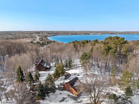 EXTERIOR:  An aerial view of the cabin with Crystal Lake in the background.