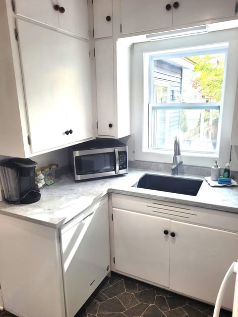 KITCHEN:  The home has a small, but very convenient, modern kitchen with all appliances (including a dishwasher) along with a good supply of cooking and dining utensils