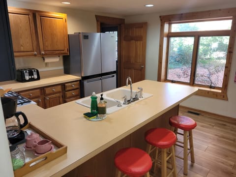 KITCHEN:  The home has a large and modern kitchen with all appliances (including a dishwasher) and a good supply of cooking and dining utensils.