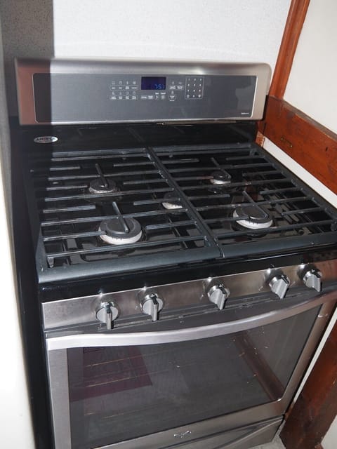 KITCHEN:  The cottage has a small kitchen with all appliances except for a dishwasher.  It does include a separate beverage cooler as well as a good supply of cooking and dining utensils.