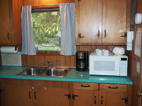 KITCHEN: The cottage has a cute little kitchen with all appliances except for a dishwasher. Includes a good supply of cooking and dining utensils.