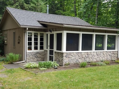 OVERALL:  The front of the cabin, highlighting the screened-in front porch