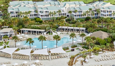 Sparkling outdoor pool surrounded by tropical greenery.