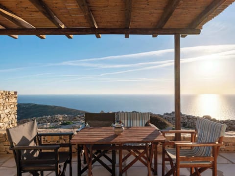 Outdoor dining with sweeping views over the Aegean Sea.