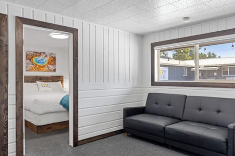 Living room with pull out sofa bed and entrance to guest room #1