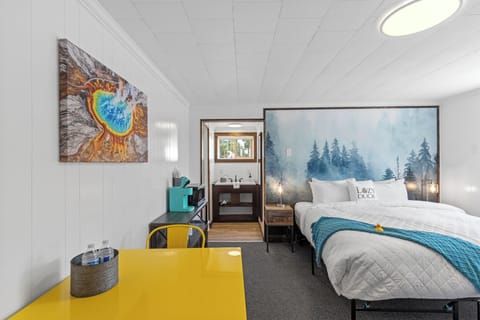 King size bed, table for two, Keurig coffee maker, microwave and entrance to bathroom