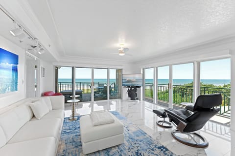 Bright and stylish living room with panoramic ocean views and modern furnishings.