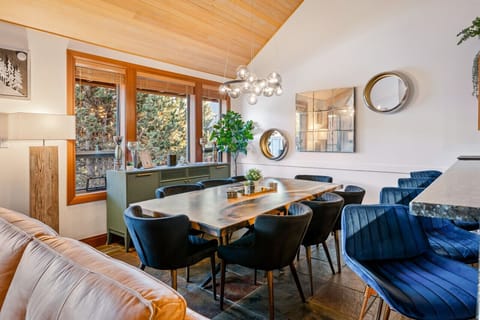 Dining room with custom made epoxy resin walnut table with seating for 8 under the high vaulted 20` cedar lined ceiling.  4 bar stools on the counter allowing for up to 12 guests to dine together. We also have a high chair for those with young ones.