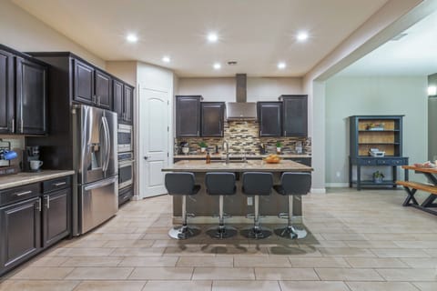 Open concept kitchen has generous counter space and island for prepping and serving your favorite cuisine.