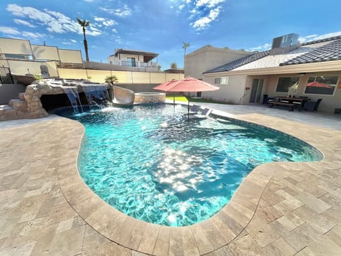 Custom pool. Huge baja shelf, 4 in-pool barstools, 44' water slide, grotto