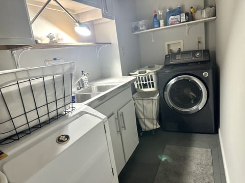 Ground floor laundry features full-size washer dryer and sink, one starter pod!