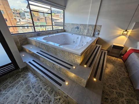 Family Suite, Multiple Beds, Hot Tub, City View | Private spa tub