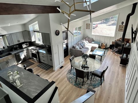 Great room including kitchen, bar, family room, and dining table. 