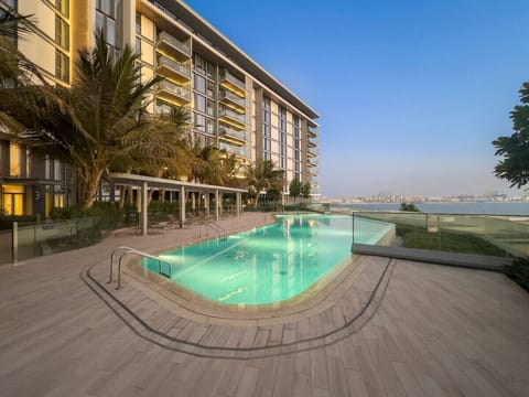 Exterior Oasis: Dive into luxury with our shimmering pool and stunning waterfront views!