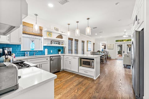 Gourmet Kitchen-Step into our updated gourmet kitchen, bathed in natural light and fully stocked with vacation essentials. Stainless steel appliances amidst the modern design, while a spacious pantry ensures your culinary needs are met during your stay.