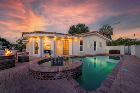 Outdoor Oasis: Unwind by the sparkling pool, surrounded by vibrant sunset views and fire pit charm!