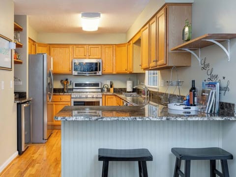 Elegance meets functionality in this modern kitchen with stainless appliances.