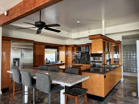 Dining/kitchen area and hall leading to main level front bedroom.