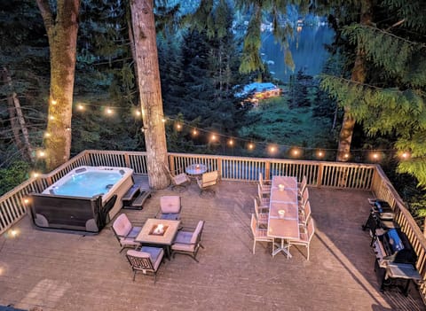 Deck with hot tub, fire table, outdoor dining table and BBQ
