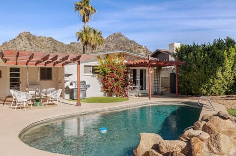 Lush backyard with Piestewa Peak views, misters, outdoor dining and private pool