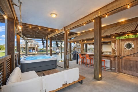 Large shaded patio featuring comfortable seating and entertainment space, perfect for gatherings and outdoor living.