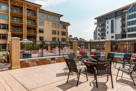 Fire pit next to the outdoor heated pool and hot tub